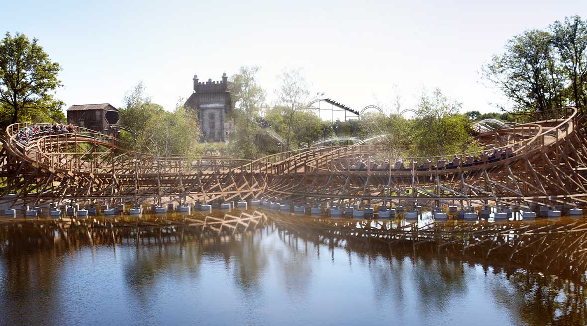 Ride at Efteling with a lake in front and treetops in the back ground