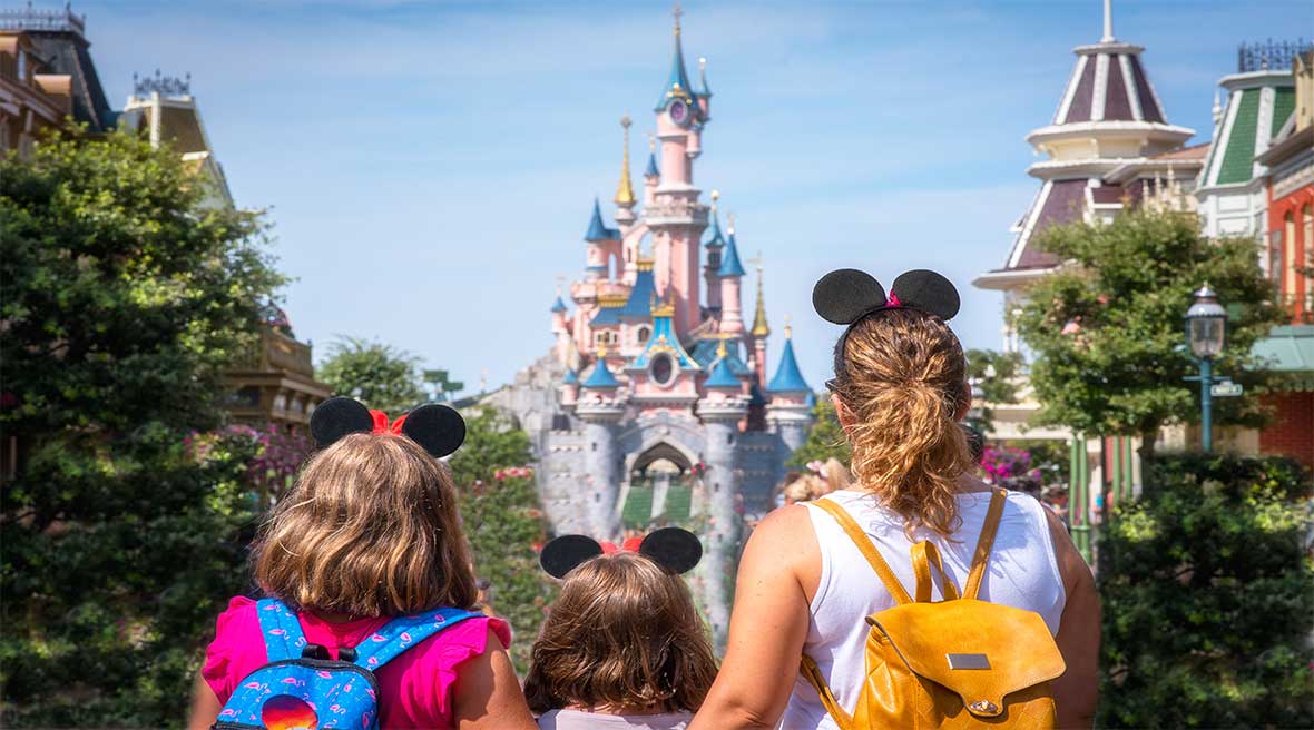 A mother and her daughters gaze at the Princess Castle the Disneyland Paris park.