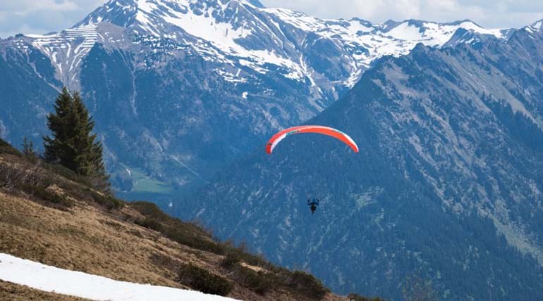 Paraglider in the sky in an Alpine region 