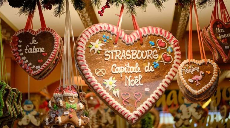Gingerbread hearts hanging from a shop window at Christmas time